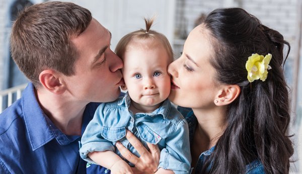 Sind Einzelkinder verwöhnt? Zwei Eltern küssen ihr Kind