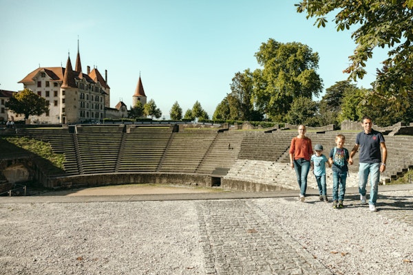 Eine Familie auf einem Rundgang an eindrücklichen antiken Monumenten. In Avenches lässt sich die römische Geschichte der Schweiz hautnah erleben.